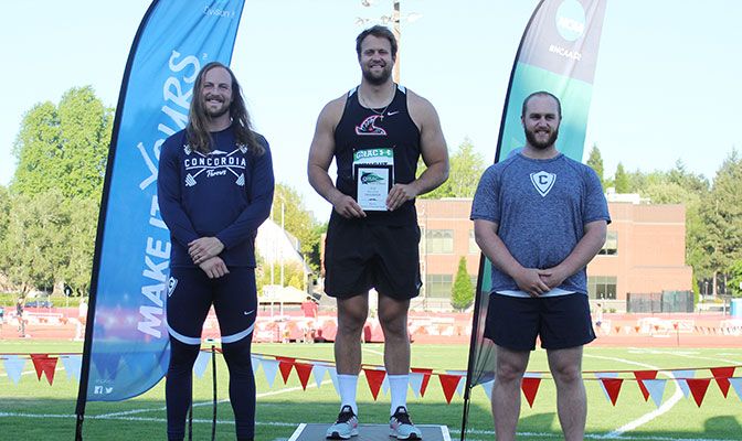 Jake Knight (center) threw 182 feet, 10 inches in the discus to surpass the previous record of 176 feet, 6.5 inches set by Concordia's Caleb Bridge (left). Photo by Jennifer Halley.