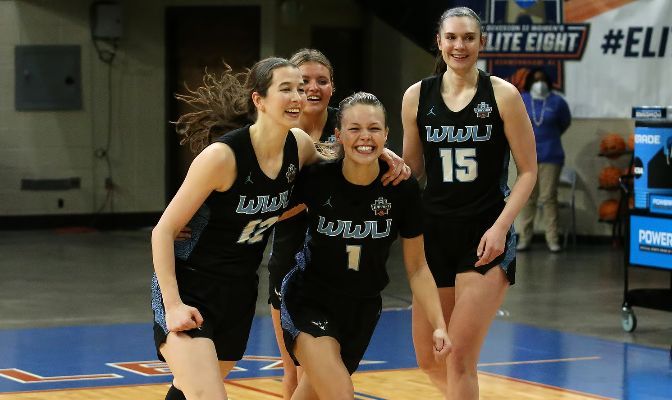 (L to R) Western Washington's Emma Duff, Riley Dykstra, Avery Dykstra and Brooke Walling celebrate their 74-68 Final Four win over North Georgia. Photo by Michael Wade.