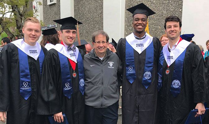 Joe Danahey (center) with some of Concordia's graduating student-athletes at the school's 2018 commencement exercises.