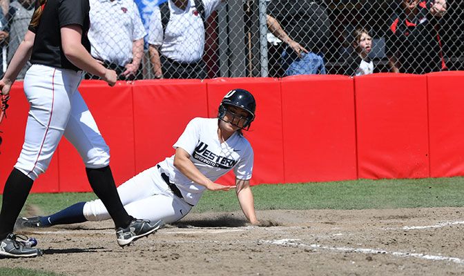 Jackie Lucido slides home for the winning run in the 10th inning to give Western Washington the 5-4 victory over Saint Martin's. Photo by Paul Dunn.