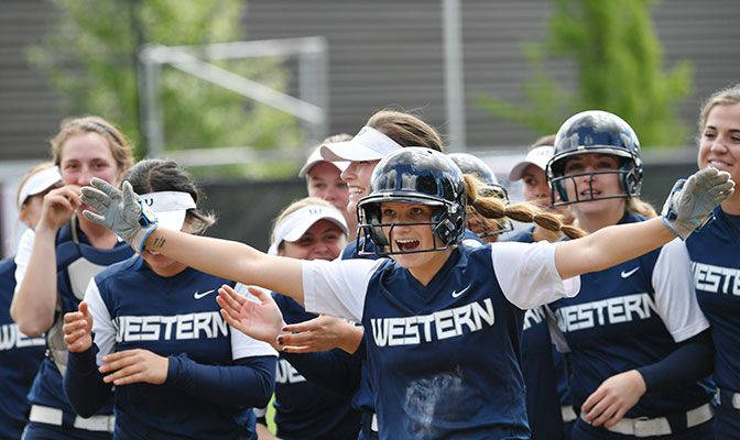 The Vikings' McKenna Mathis celebrates as Anna Kasner scores for a 2-1, eight-inning win over Western Oregon. Photo by Paul Dunn.