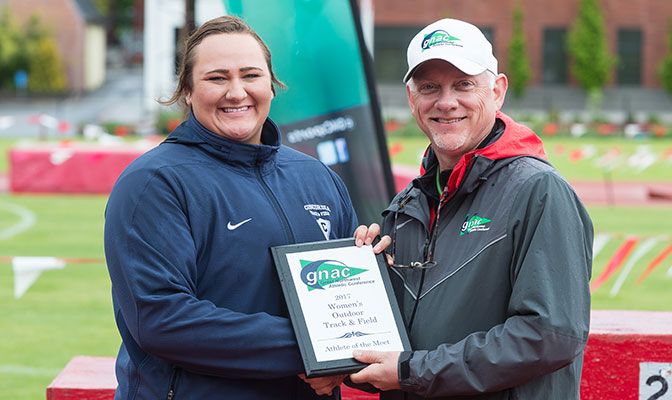 Concordia's McKenzie Warren (shown with GNAC commissioner Dave Haglund) was named the Female Outstanding Athlete of the Meet. Photo by Chris Oertell.