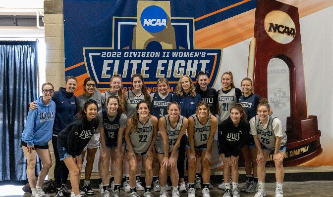 The WWU women's basketball team poses in front of Elite Eight signage in Birmingham, Alabama. The Vikings advanced to the national quarterfinals with a victory over Cal State East Bay.