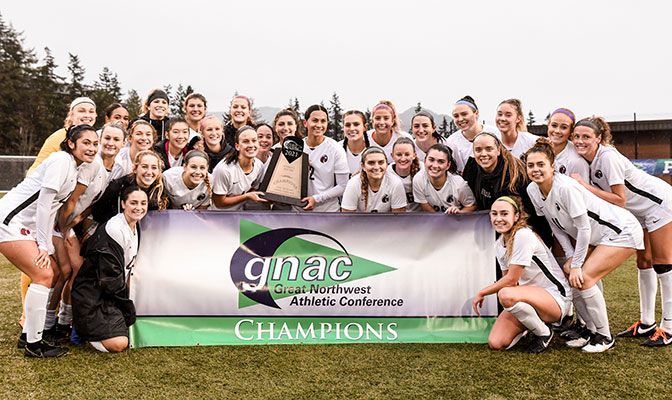 Members of the GNAC champion Falcons pose with the trophy after defeating Western Washington 4-0.
