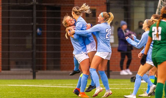 Jenna Killman (second from left) leaps into the arms of Grace Eversaul (left) after scoring against Point Loma. Western Washington beat PLU 1-0 to advance to the next round of the NCAA Tournament.