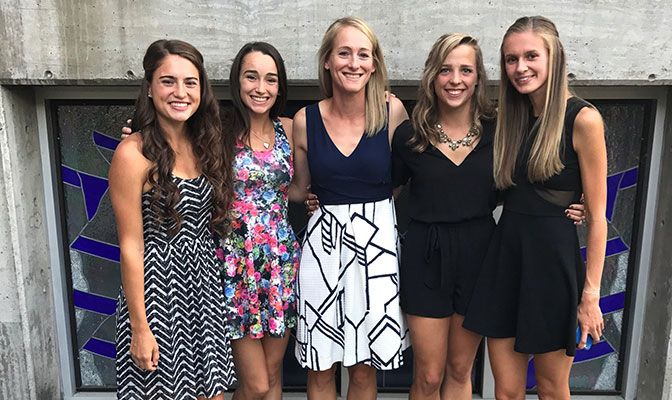 Emily Vala-Haynes (center) at WOU's 2018 commencement with student-athletes (from left) Felicia Covey, Suzanne Van De Grift, Megan Rose and Kennedy Rufener.