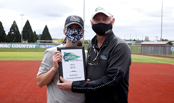 Anna Kasner, pictured with GNAC Commissioner Dave Haglund, was named MVP after going 3-0 in the tournament, allowing one run and striking out 38. Photo by Jaime Valdez.