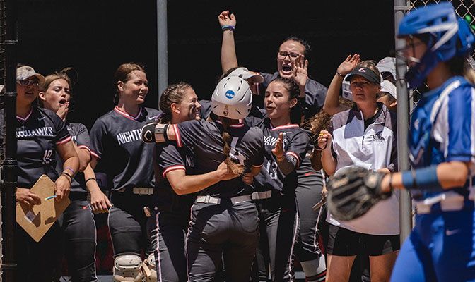 The Northwest Nazarene dugout congratulates Ivy Hommel after she scored in the Nighthawks' three-run fifth. Photo by Alan Brown.