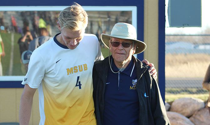 Harris, shown here with 2017 MSUB men's soccer player Niklas Schregel, retired this spring after 31 years at Montana State Billings.