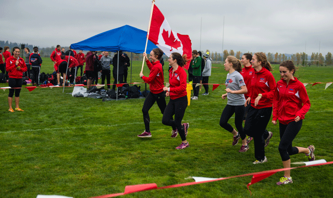 SFU displays national pride after winning GNAC title Nov. 1. Holding flag is Jennifer Johnson. To her left is Brittany Evans, Julia Howley, Miryam Bassett,  Emma Chadsey and Sophie Dodd. (CJImages)