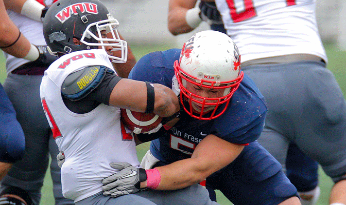 Casey Chin garners one of his 110 tackles in a game earlier this season against Western Oregon's Nathaniel Penaranda.