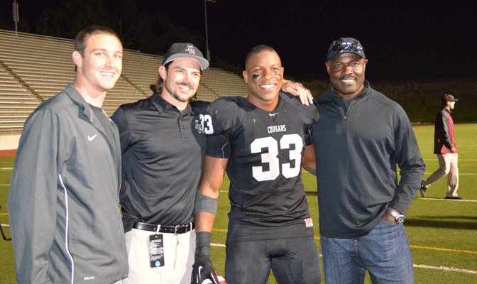Terrell Watson's performance was witnessed Saturay by Azusa Pacific's previous Top 3 career touchdown leaders, from left, John van den Raadt, Ben Buys and Christian Okoye. (Photo by Holly Magnuson)