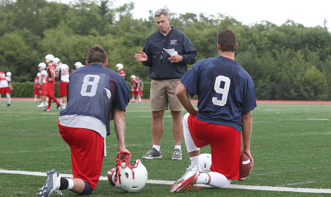 Jacques Chapdelaine talks to quarterbacks Janne Lehtinen (8) and Tyler Nickel (9) at a recent SFU practice.