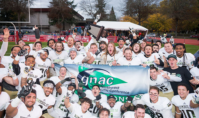 Humboldt State celebrates after receiving the GNAC championship trophy following their No.v 14 game at Western Oregon. Photo by Neil E. Gravatt.