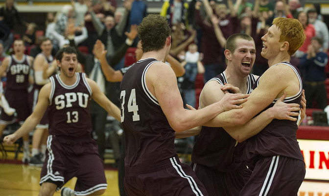 Jobi Wall is congratulated by teammates Ryan Todd (13), Cory Hutsen (34) and Riley Stockton moments after nailing three-pointer to give Falcons 72-70 victory in GNAC championship game Saturday.