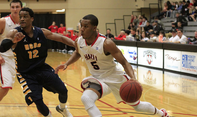 Mario Donaldson (guarded by Devon Wallace) led Northwest Nazarene to a 66-60 win over MSU Billings Thursday, but the Yellowjackets still clinched a GNAC playoff berth when CWU lost to SPU.