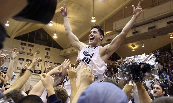 Richard Woodworth is raised above the floor by the Vikings faithful after hitting a miracle half-court 3-pointer to win the game for WWU at the buzzer (Photo by Nick Gonzales).