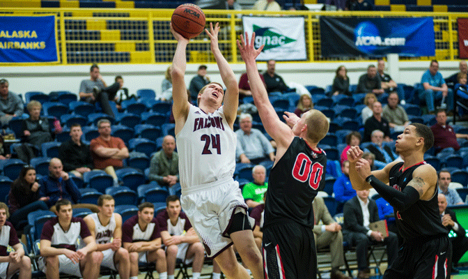 SPU's Mitch Penner (24) tries to manuever past NNU's Alex Birketoft during second half of Friday's semifinal game  (Photo by Aaron Selig)