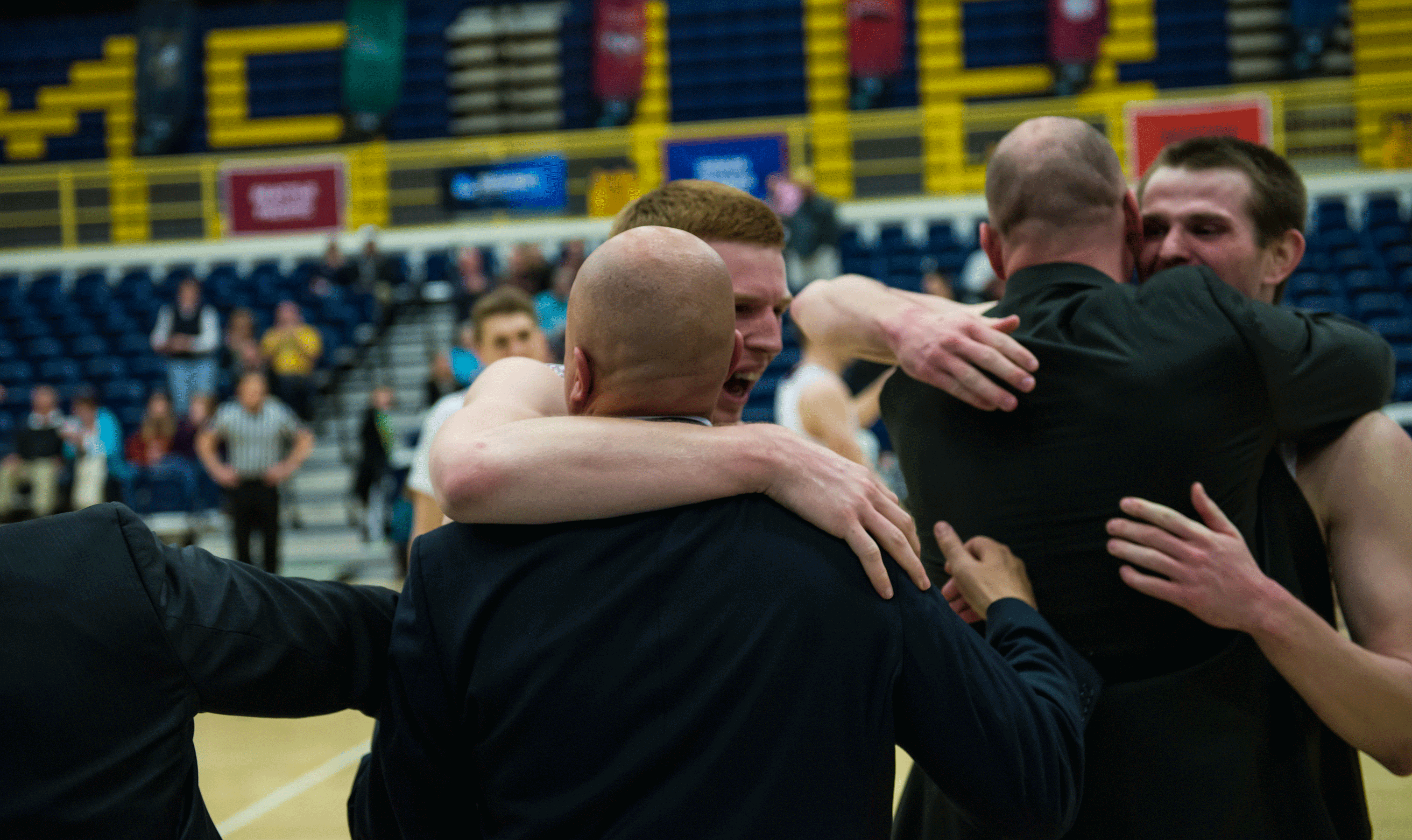 Coach Ryan Looney, Mitch Penner, assistant coach Grant Leep and Riley Stockton celebrate win (Photo by Aaron Selig)