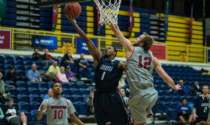 WOU's Lewis Thomas (12) attempts to block shot by Ricardo Maxwell (1) as Julian Nichols (10) looks on in Friday's second semifinal (Photo by Aaron Selig)