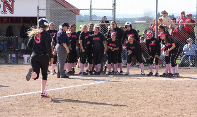 Western Oregon awaits the arrival of Ashlie Gardner (9) at home plate, after her home run in the bottom of the sixth capped a 4-0 win over Central Washington on Sunday.