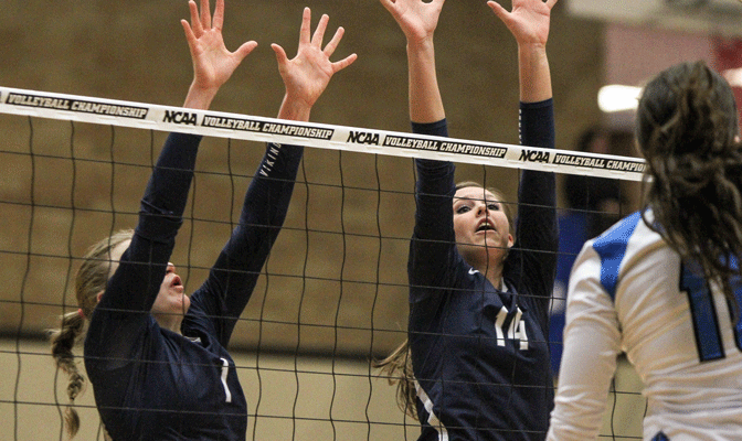 Joellee Buckner (14) and Kristina Tribley go up for a block in Thursday's match (Photo by Loren Orr)