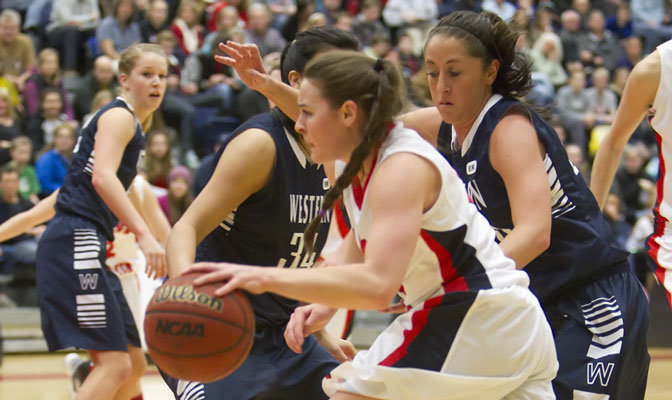 Carla Wyman drives past two Viking players in Saturday's victory.