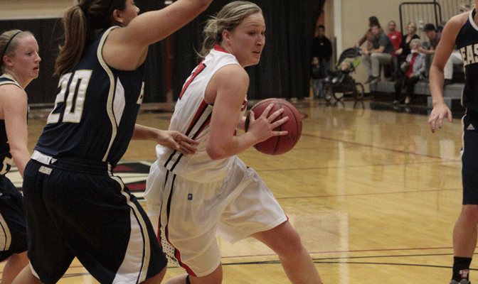 NNU senior guard Megan Hingston (white) notched 27 points Tuesday, helping Crusader head coach Ryan Bragdon to his first career victory.
