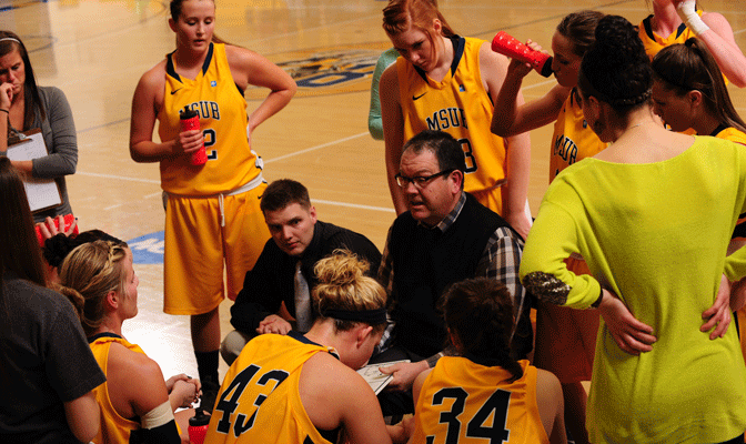 MSU Billings head coach Kevin Woodin (center) guided the Yellowjackets to a third-place finish in the GNAC standings in 2012-13.