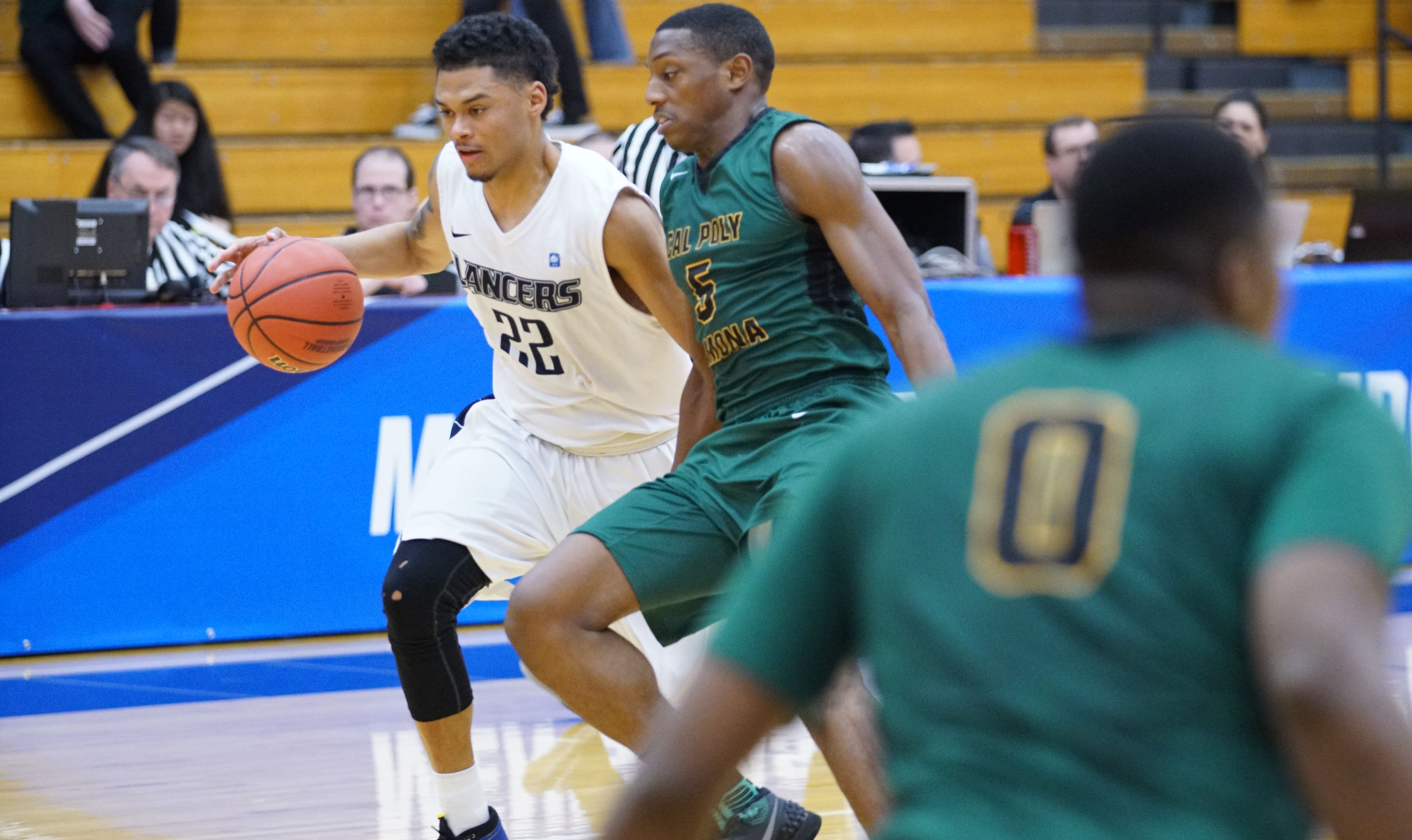 2015-16 PacWest Player of the Year Michael Smith (left) is guarded by Cal Poly Pomona's Barry Bell in Friday's NCAA tournament opener won by CBU 70-63