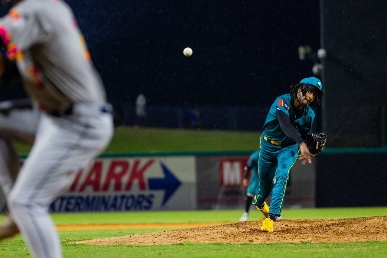 Mississippi Mud Monsters pitcher in front of an outfield wall sign at Trustmark Park