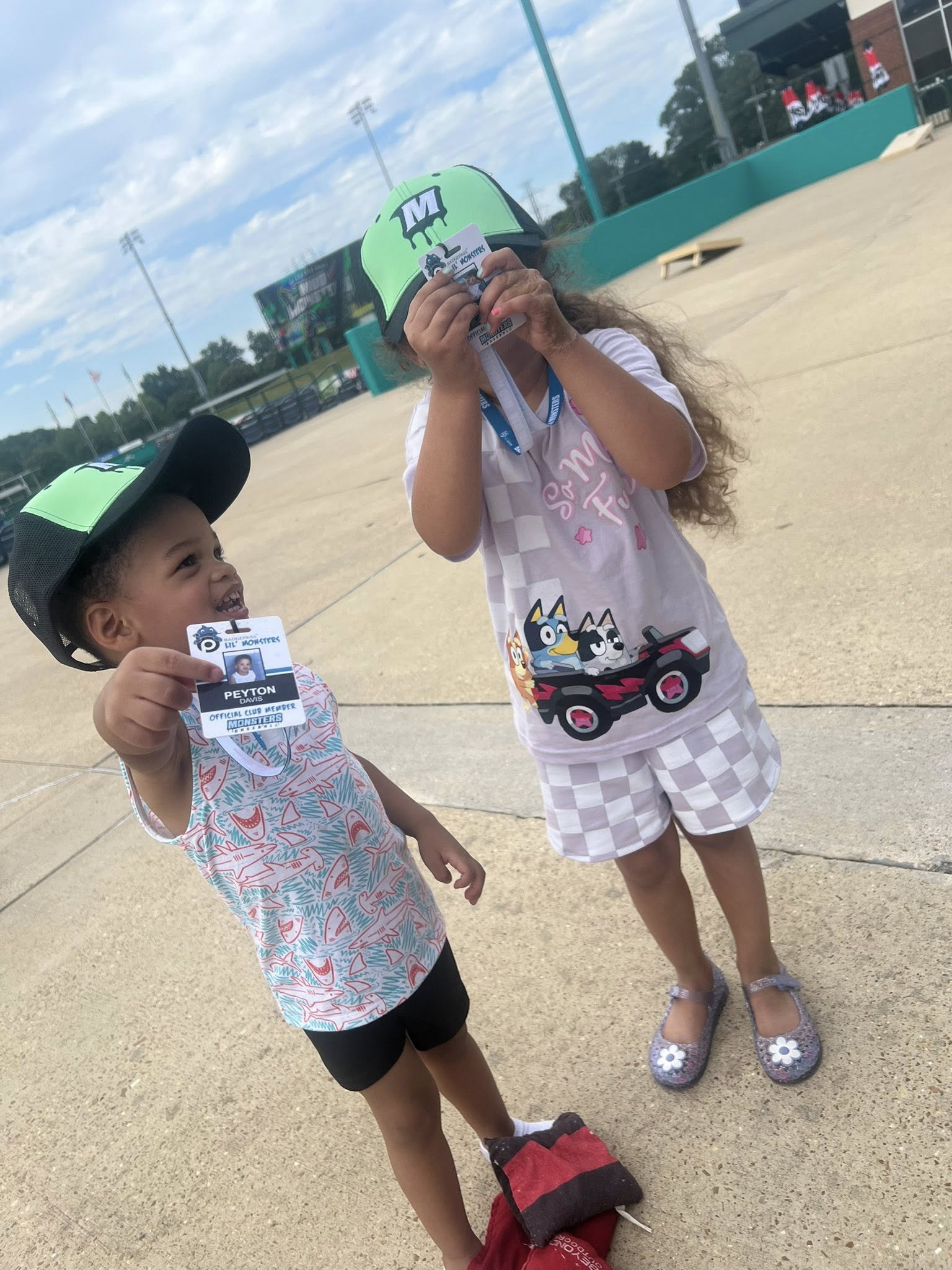 Kids holding BadgePass Lil' Monsters Club name card