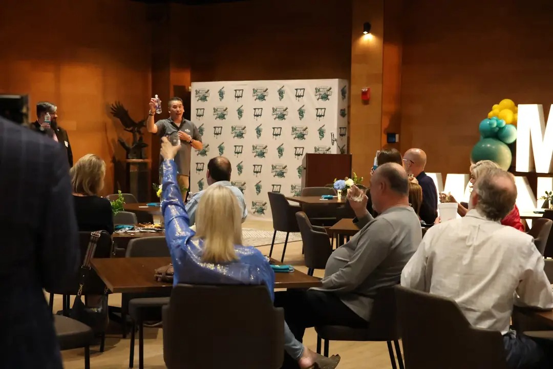 Joe Eng raising a toast at the logo reveal party