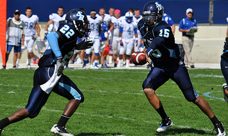 San Diego quarterback Mason Mills, here handing off to running back Kenny James, leads the Toreros eastward to face Harvard in one of three PFL-Ivy League matchups in Week 3.