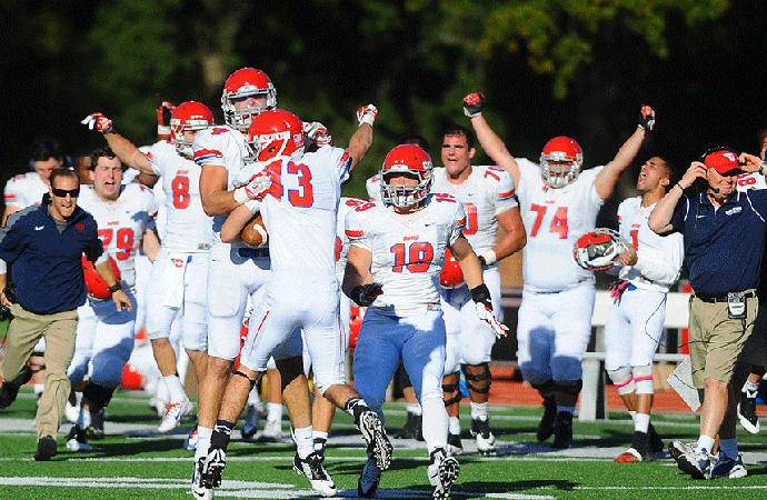 Dayton celebrates following Tom Fanning's (No. 43) interception to end a five-overtime contest that sealed a 54-58 victory. (Photo by Tim Cowie)