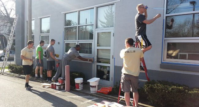 Valpo Football Players Paint the Hilltop Neighborhood House